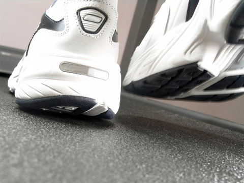 Closeup view of brand new sport shoes running on a treadmill