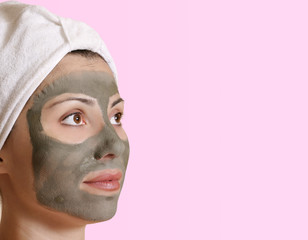 Female with a clay beauty mask and space for  message.