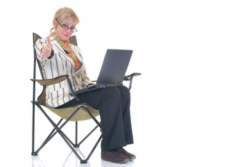 Attractive blond young businesswoman in director chair,