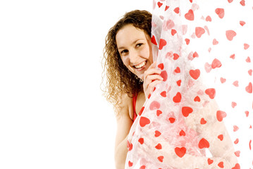 Obraz na płótnie Canvas Valentine girl smiling from behind the love curtains