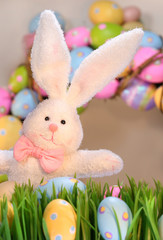 White rabbit with colored eggs for Easter
