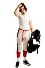 An American football player. Standing with shoulder pads.