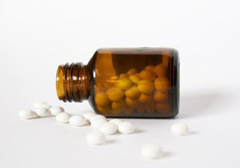 open bottle of prescription medicine and its content of pills