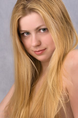 Fototapeta premium close-up portrait of blond young gray-eyed woman