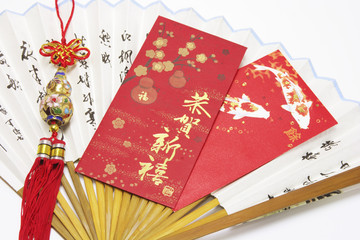 Fototapeta premium Red Packets and Trinket on Paper Fan