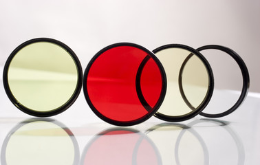 Row of four photo filters with reflection