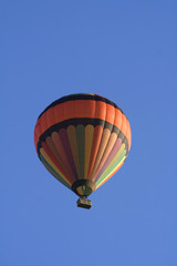 Hot air balloon flying in blue sky