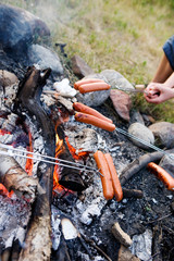 A wiener roast over an open fire