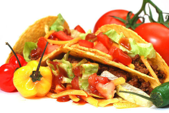 Closeup of tacos with tomatoes, habanero and serano peppers.  