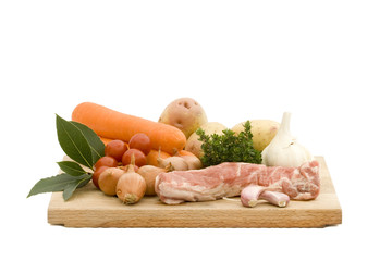 Uncooked lamb with fresh vegetables and herbs