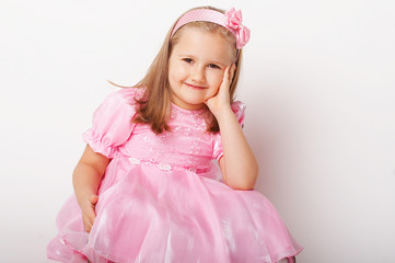 Nice young girl in pink on light background