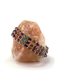 Rose quartz with bracelet on white background