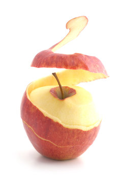 red peeled apple. peel levitates showing pulp