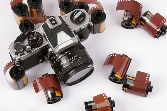 Closeup image of 35mm films and a SLR Camera.