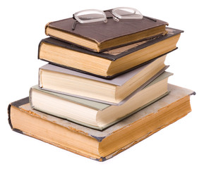 Reading - glasses on a pile of books  