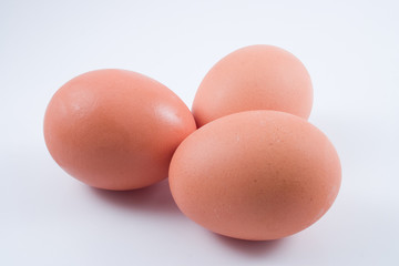 Three eggs isolated on white, with shadow