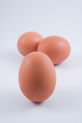 Three eggs isolated on white, with shadow