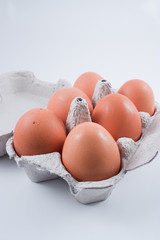 eggs in a box isolated on white, with shadow