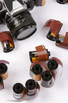 Closeup image of 35mm films and a SLR Camera.