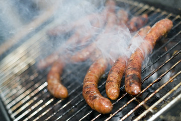 Barbecue sausage on grill with smoke