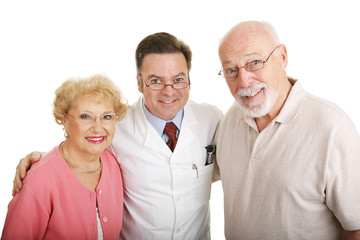 Senior couple in their new glasses with their optometrist. 