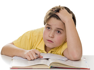 Young boy dreaming at homework