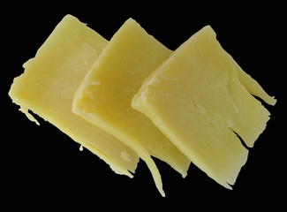 Hard cheese pieces isolated on black