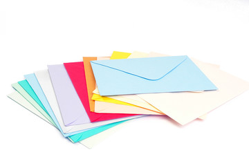 Pile of empty envelopes in various colors over white background