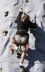 girl climbing artificial wall