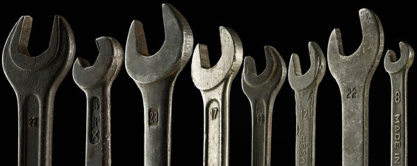a set of eight wrenches of different sizes - on black