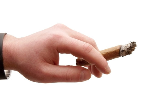 Hand holding a cigar smoking