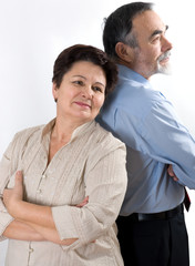 elderly couple standing back to back