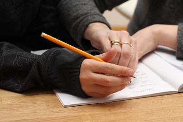 Mother helping her son do his homework for school,