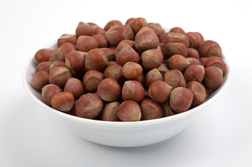 Hazelnuts on white bowl