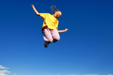 Fototapeta na wymiar Teen girl jumping in air