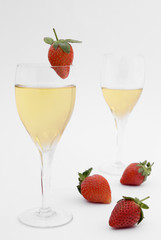 Two champagne glasses with fresh ripe strawberries