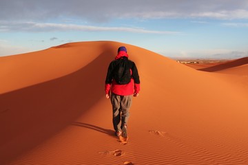 Man go up in sand desert
