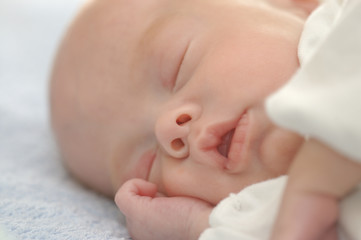 face of a baby sleeping placidly