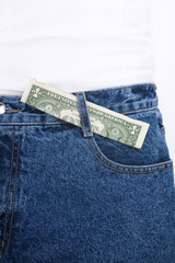 a blue jean and dollars close up shot