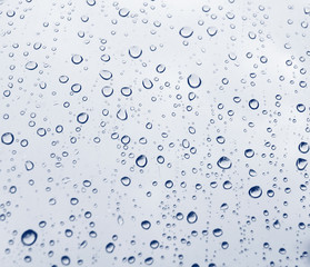 Fototapeta na wymiar Blue Rain Drops on a window
