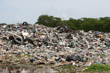 A pile of waste including dicarded tires, plastic, etc