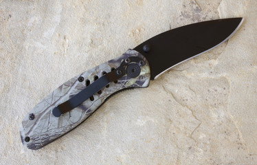 folding hunting knife with a camo pattern