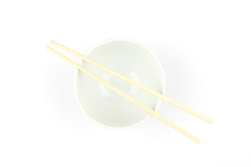 Noodle bowl and chopsticks against a white tablecloth.