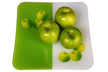 Three fresh apples in a plate on a white background