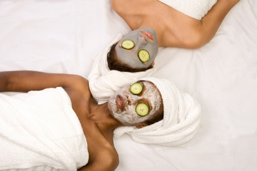 Two girls are relaxing during facial mask application in spa