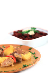 close up of a steak and potatoes arranged in a plate