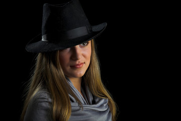 young woman in black hat on black