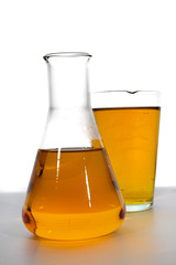 isolated laboratory glass with yellow solution