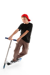 Child manoeuvring a scooter on a white backdrop