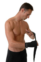 A boxer wrapping his hands in tape